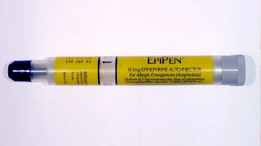 auto-injector pen applied to the thigh