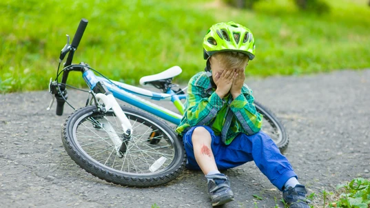 crying child that had fallen from a bicycle