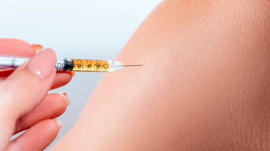 Injection into the shoulder with an insulin syringe