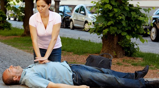 Lady giving service man CPR