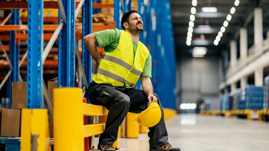 Male Warehouse Worker with Back Pain 