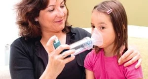 Mum helping child with asthma attack