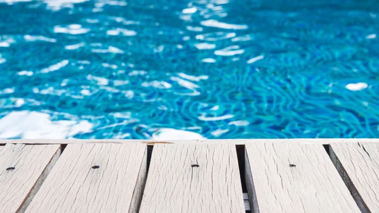Swimming pool and wooden deck ideal for backgrounds